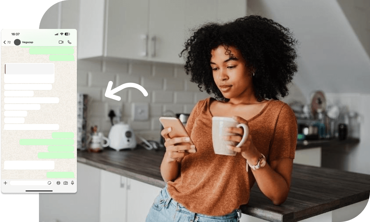 Woman using her cell phone and holding a cup in her hand